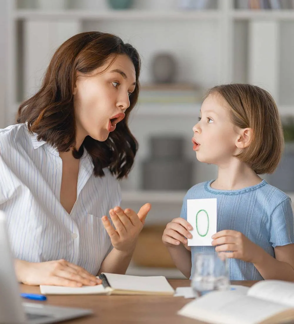 A BSPS therapist celebrating progress with a young child