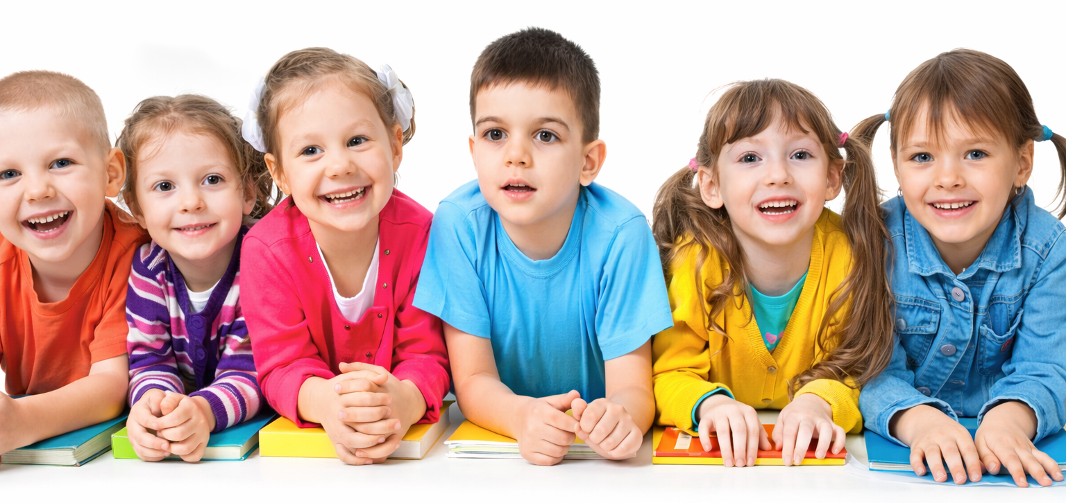 Diverse group of smiling children lying on the floor with colorful books